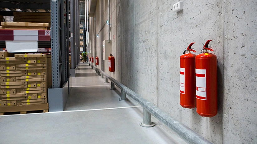 Fire extinguishers installed in a warehouse.