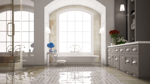 Water flooded bathroom with a white tile floor.
