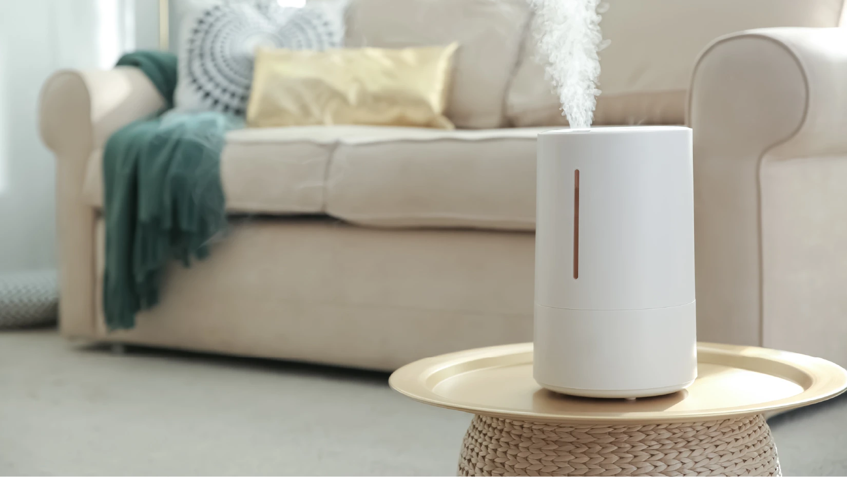 A white humidifier sits on a coffee table in a living room.