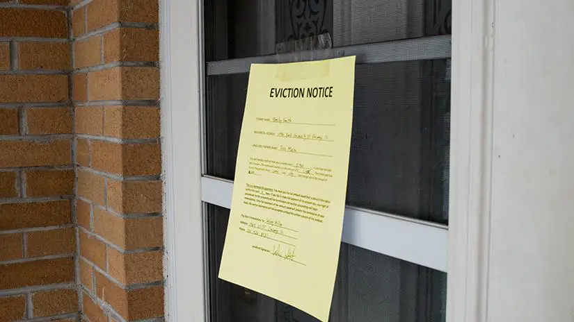 Eviction notice taped to front door.